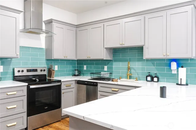 a kitchen with a sink stove and cabinets