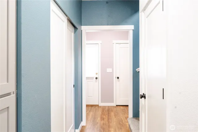 a view of a hallway with wooden floor