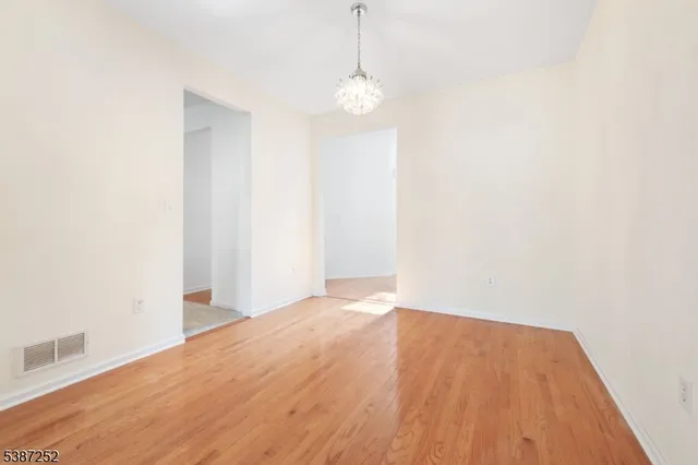 a view of a room with wooden floor and windows