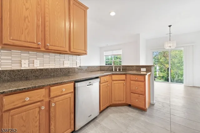 a kitchen with granite countertop a sink stainless steel appliances white cabinets and a granite counter tops