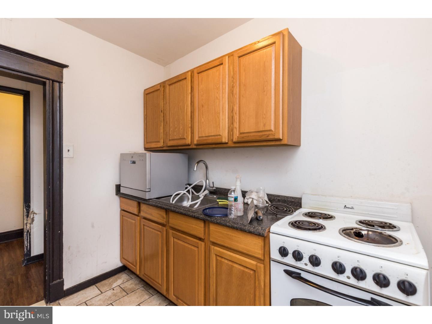 5013 Chester Avenue, Unit 3 Philadelphia, PA 19143 - Photo 11 of 17 a kitchen with stainless steel appliances a stove a microwave and cabinets