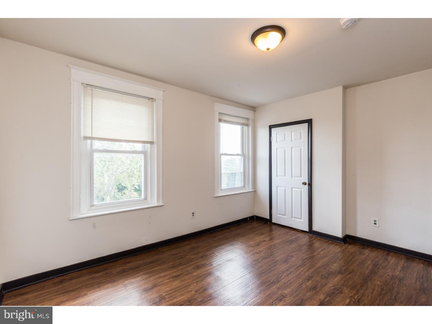 5013 Chester Avenue, Unit 3 Philadelphia, PA 19143 - Photo 13 of 17 a view of an empty room with wooden floor and a window