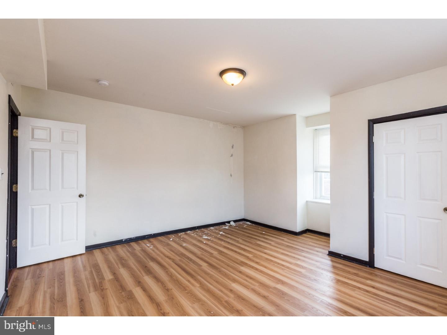5013 Chester Avenue, Unit 3 Philadelphia, PA 19143 - Photo 4 of 17 wooden floor in an empty room with a window