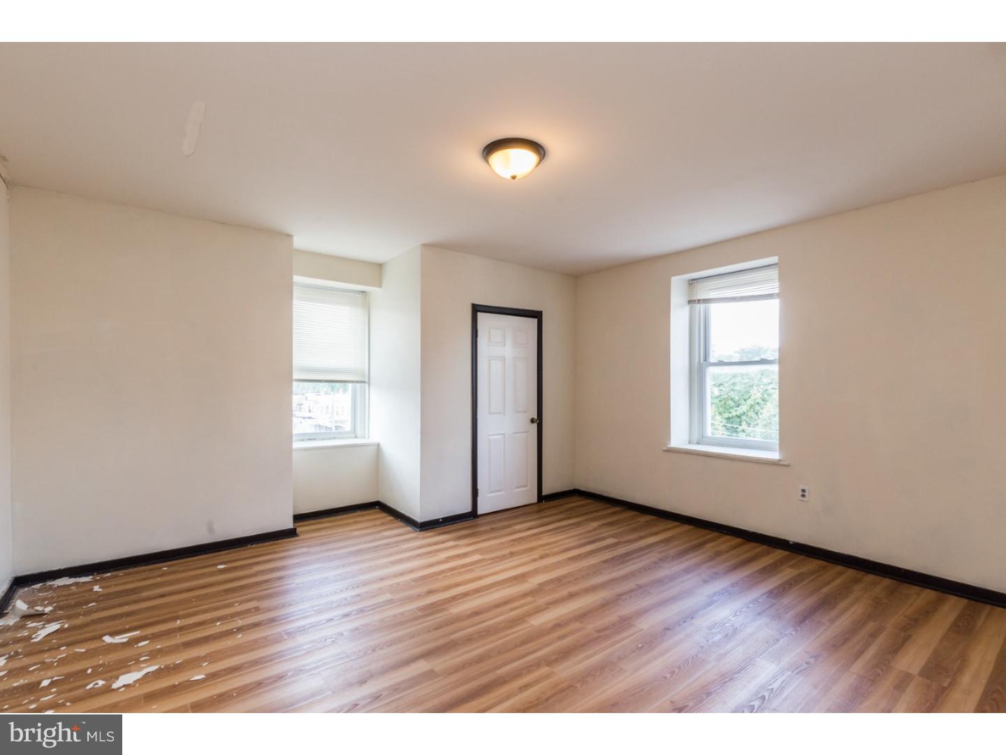 5013 Chester Avenue, Unit 3 Philadelphia, PA 19143 - Photo 6 of 17 a view of an empty room with wooden floor and a window