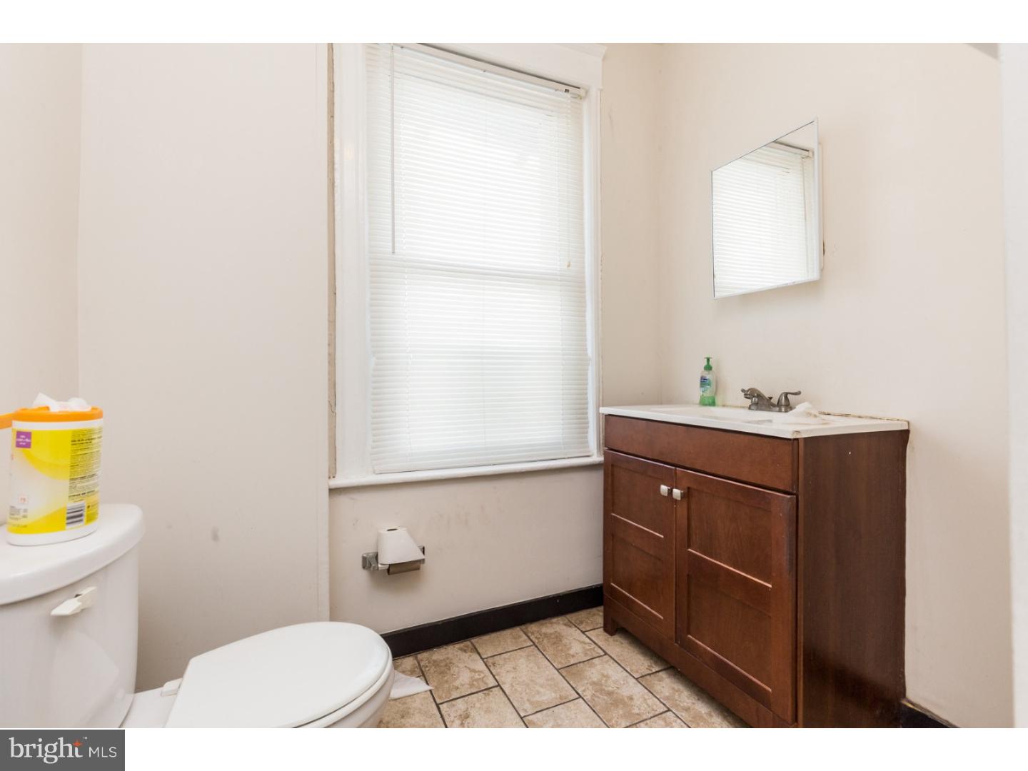 5013 Chester Avenue, Unit 3 Philadelphia, PA 19143 - Photo 9 of 17 a bathroom with a sink a toilet and mirror
