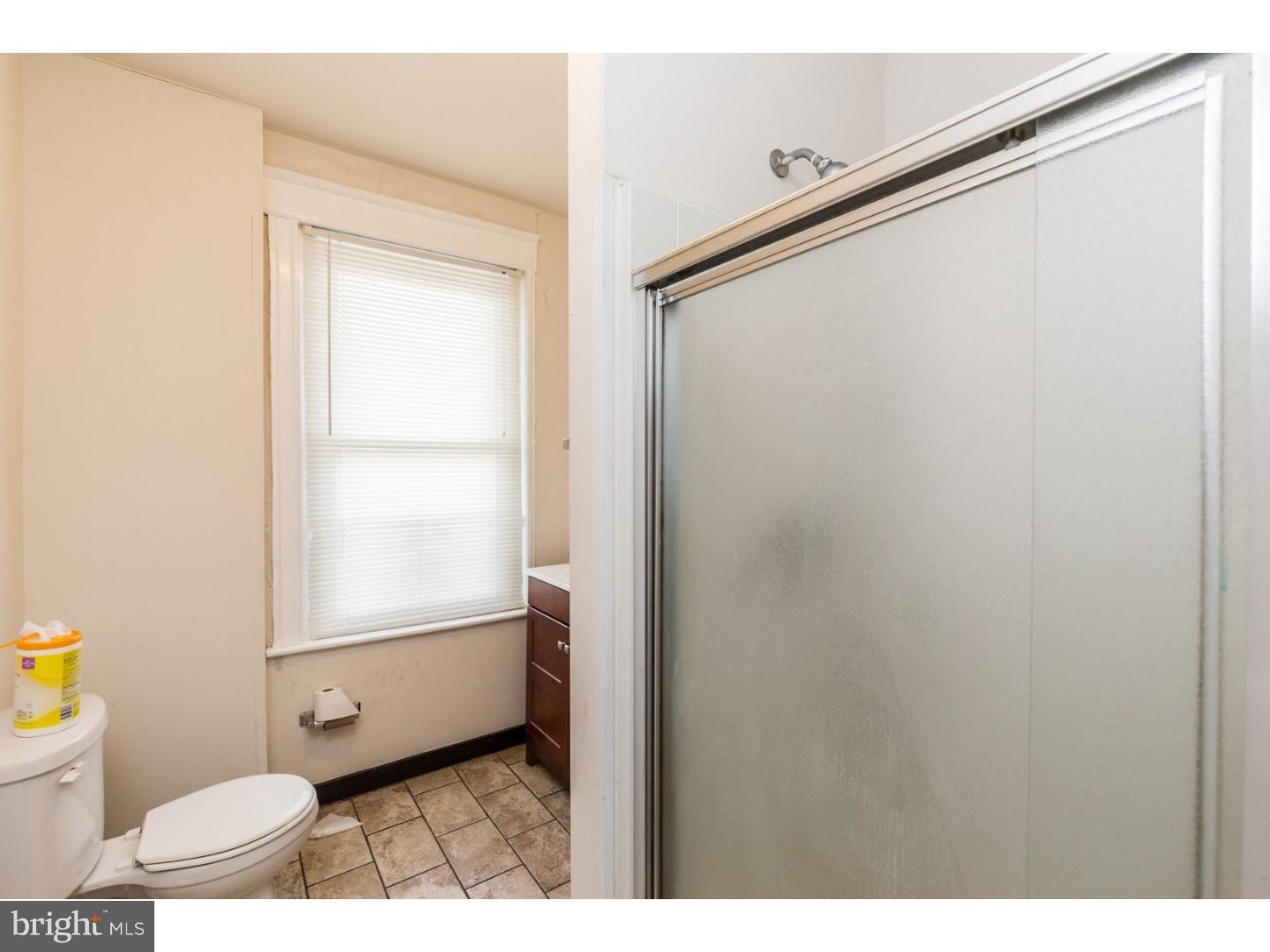 5013 Chester Avenue, Unit 3 Philadelphia, PA 19143 - Photo 10 of 17 a bathroom with a toilet sink and a mirror