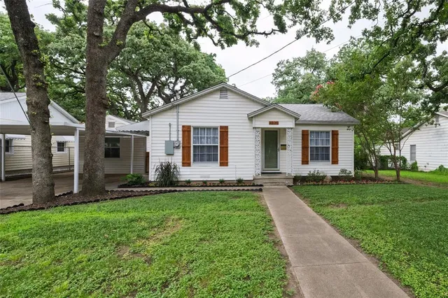 a front view of house with yard and green space