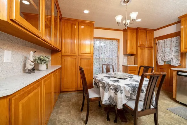 a view of a dining room with furniture and chandelier