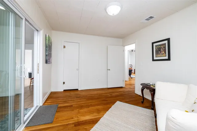 a dining room with furniture and large windows