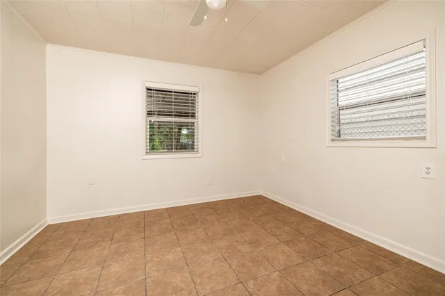 an empty room with windows and closet
