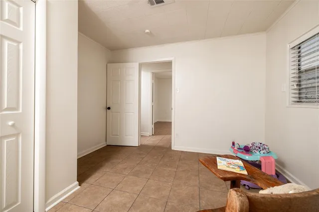 a hallway with a stove a mirror and cabinets