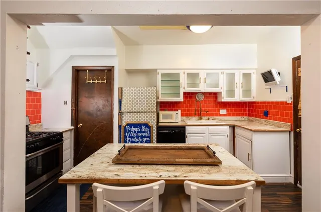 a kitchen with stainless steel appliances granite countertop a stove and a refrigerator