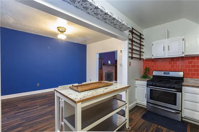 a kitchen with a stove and a microwave