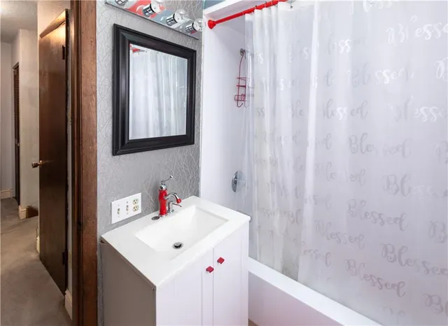 a bathroom with a sink vanity and a mirror
