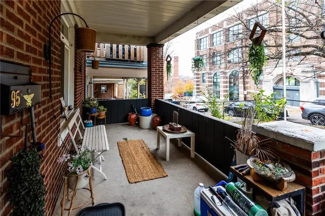 a living room with furniture a rug and a window