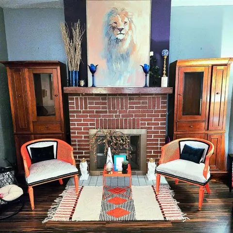 a living room with furniture fireplace and rug