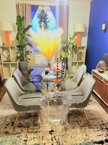 a living room with couches and potted plants on the table