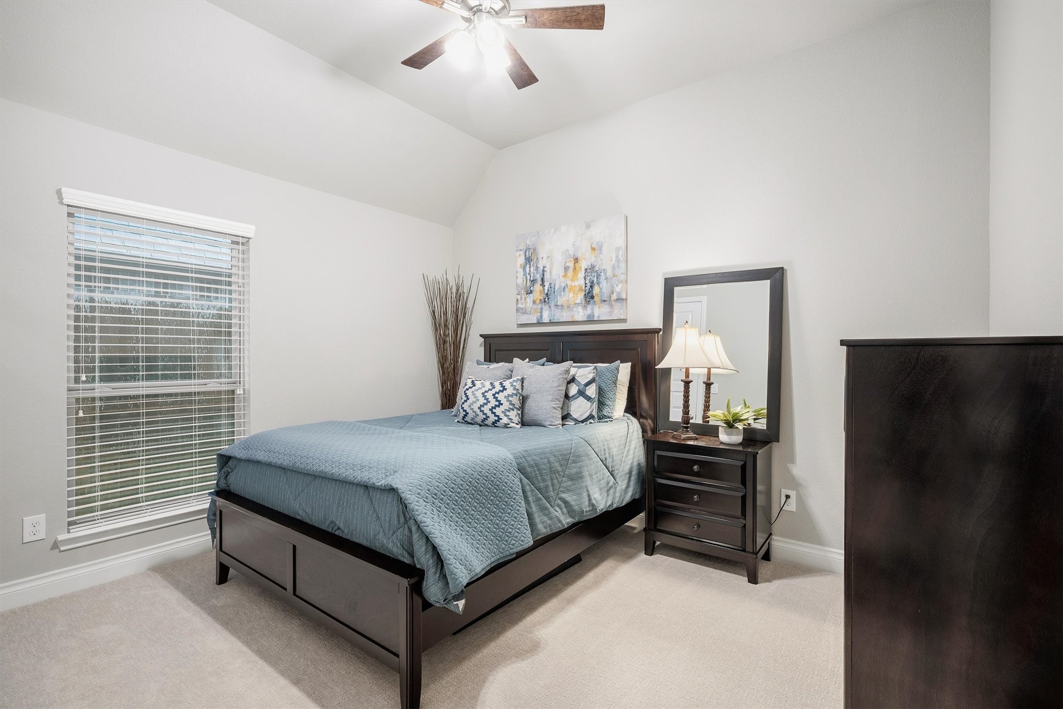 29118 Lantana Ridge Court Fulshear, TX 77441 - Photo 13 of 29 This bedroom showcases soft carpeting, a classic ceiling fan, and a window with privacy blinds, creating a comfortable and inviting retreat.