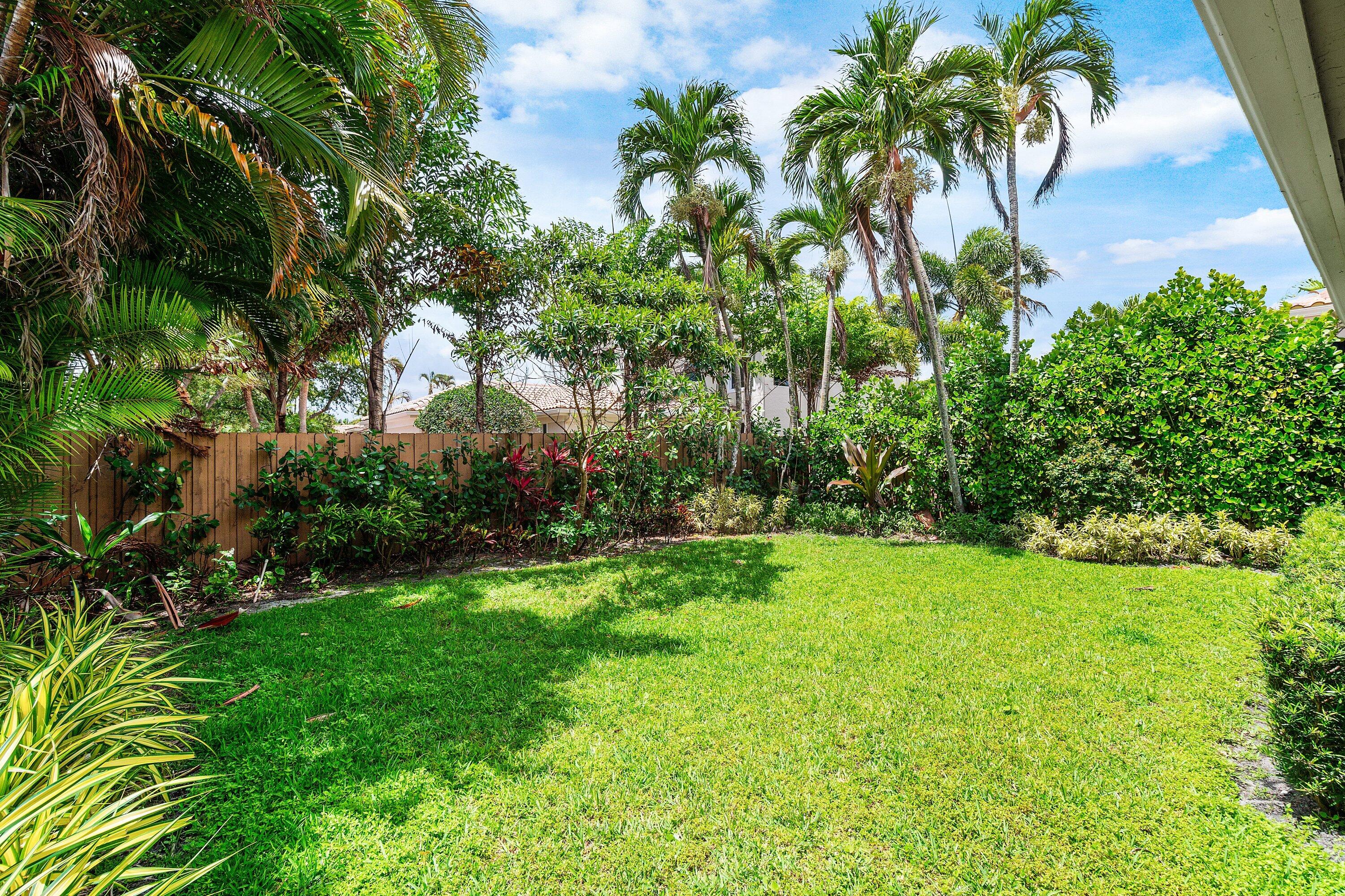 2404 Northwest 67th Street Boca Raton, FL 33496 - Photo 40 of 74 a view of a garden with a tree