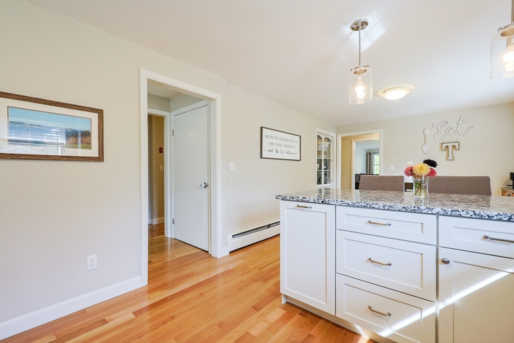 123 Harris Road Ashburnham, MA 01430 - Photo 11 of 32 a kitchen with granite countertop white cabinets and wooden floor