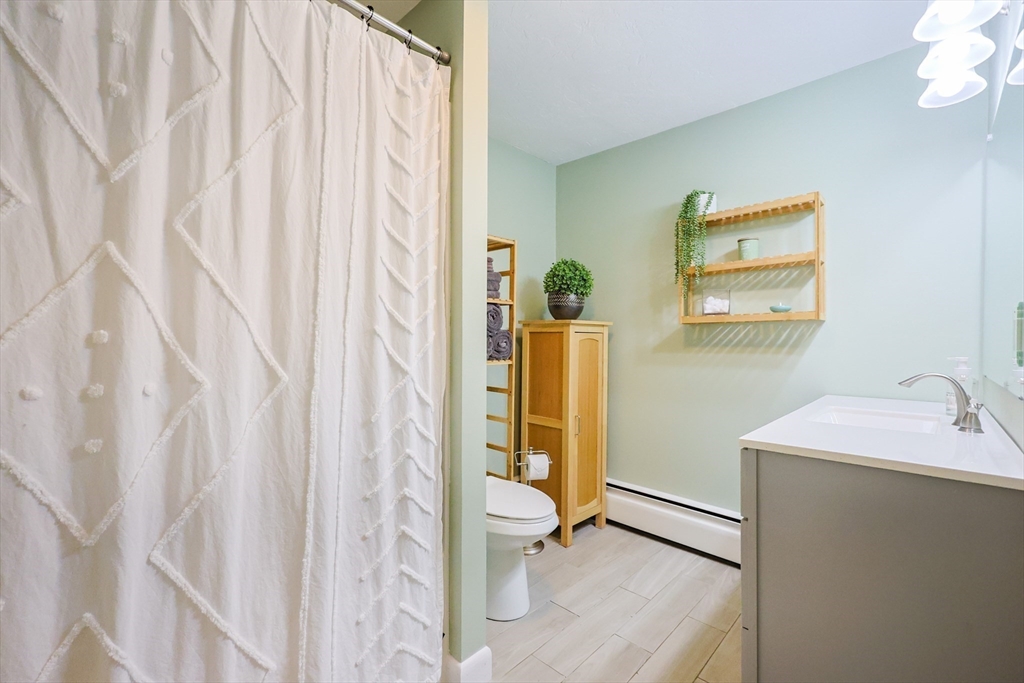 123 Harris Road Ashburnham, MA 01430 - Photo 17 of 32 a bathroom with a sink a toilet and shower curtain
