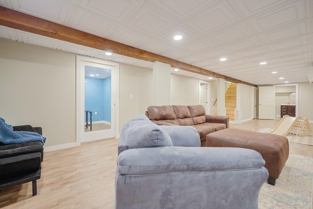 123 Harris Road Ashburnham, MA 01430 - Photo 20 of 32 a living room with couches and kitchen view with wooden floor