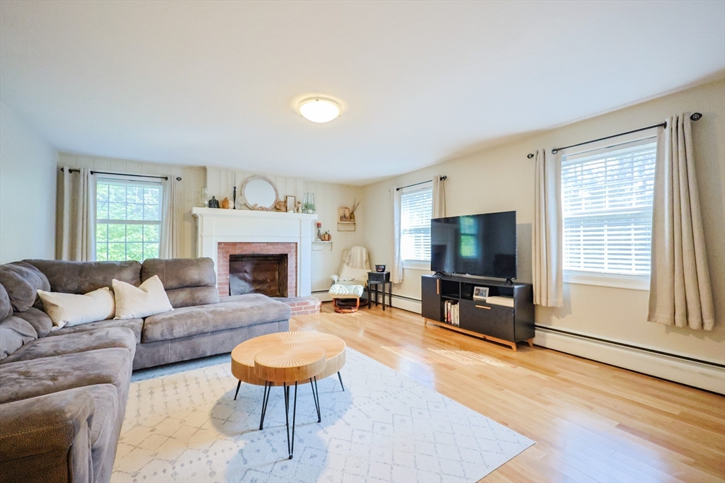 123 Harris Road Ashburnham, MA 01430 - Photo 3 of 32 a living room with furniture a flat screen tv and a fireplace