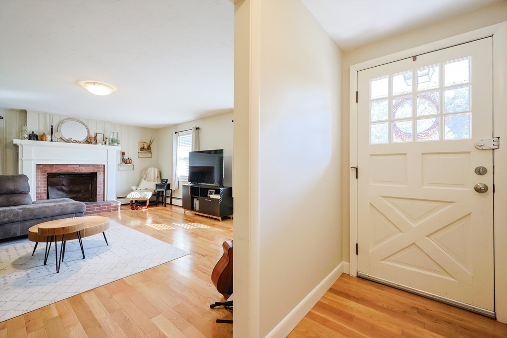 123 Harris Road Ashburnham, MA 01430 - Photo 6 of 32 a living room with furniture a fireplace and a flat screen tv