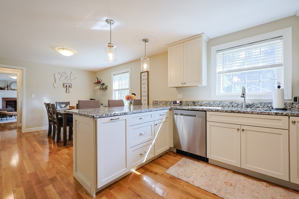 123 Harris Road Ashburnham, MA 01430 - Photo 9 of 32 a kitchen with granite countertop sink window and white cabinets