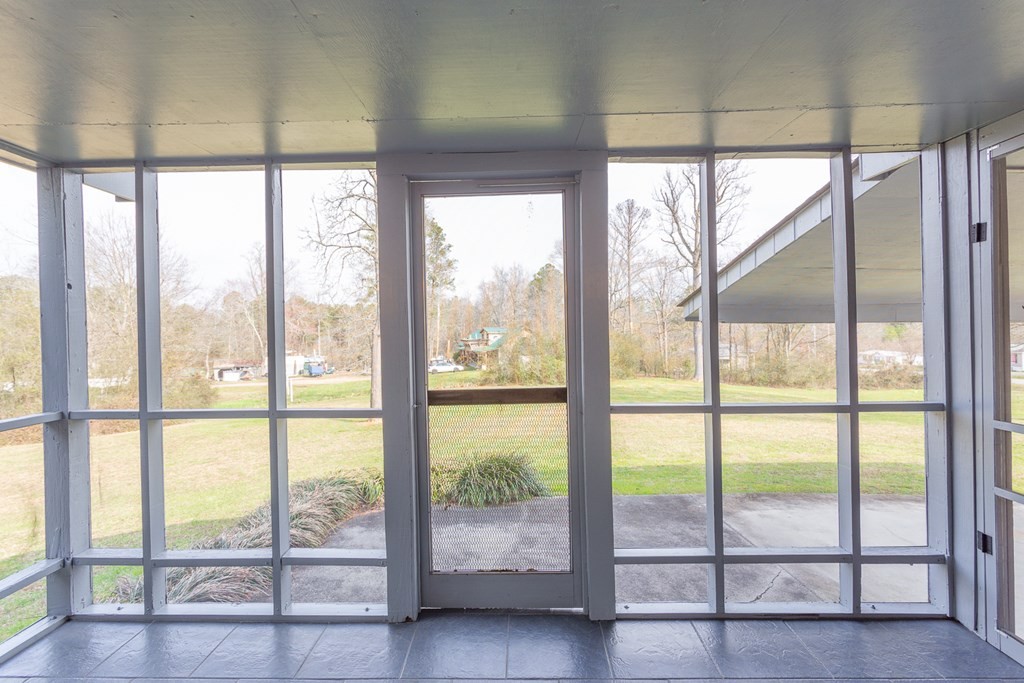 1694 Nickelsville Road Resaca, GA 30735 - Photo 27 of 58 a view of an empty room with wooden floor and floor to ceiling windows