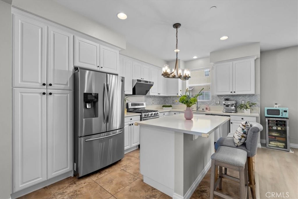 5565 Ocean, Unit 103 Hawthorne, CA 90250 - Photo 11 of 56 a kitchen with kitchen island granite countertop appliances cabinets and a counter top space