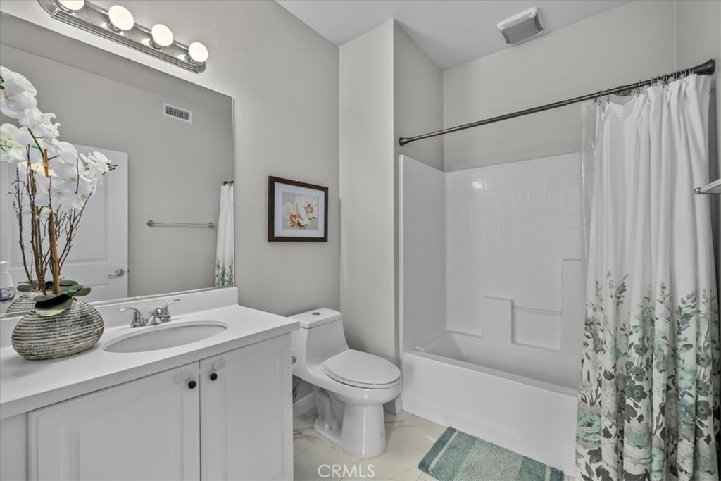 5565 Ocean, Unit 103 Hawthorne, CA 90250 - Photo 25 of 56 a bathroom with a granite countertop sink toilet a large mirror a shower and a bathtub