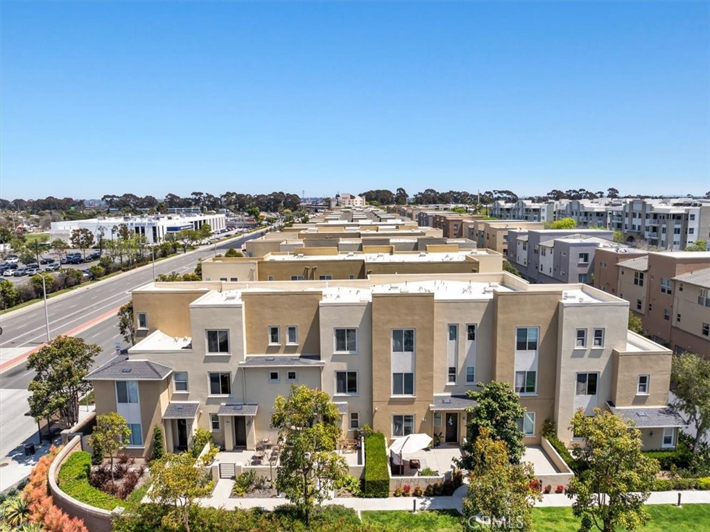 5565 Ocean, Unit 103 Hawthorne, CA 90250 - Photo 46 of 56 a view of a white house with a yard and potted plants