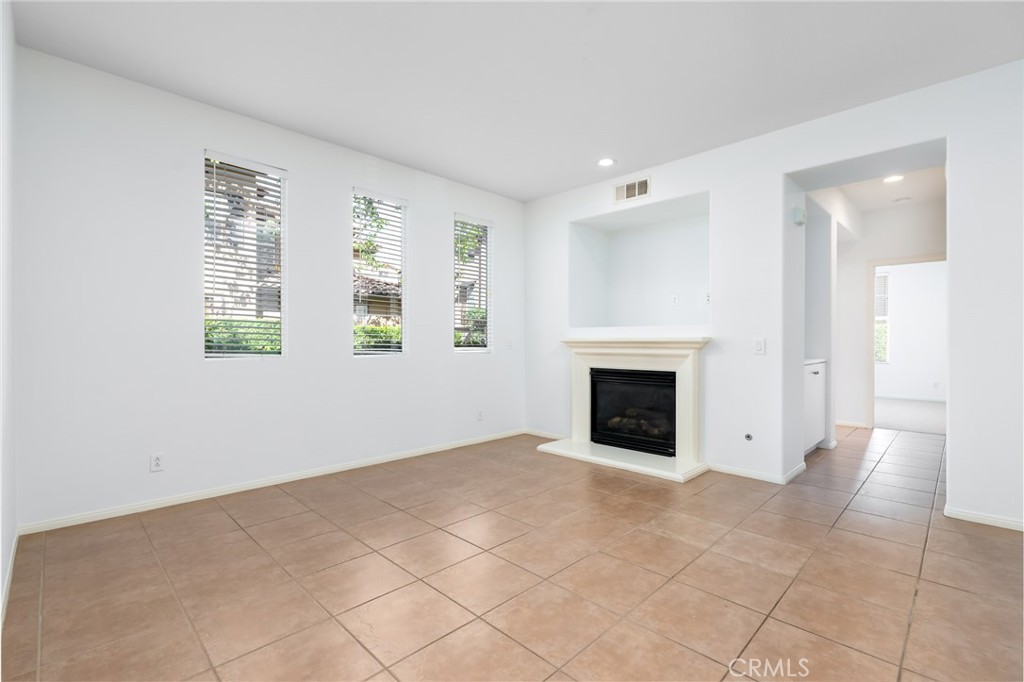 63 Nightshade Irvine, CA 92603 - Photo 2 of 15 an empty room with windows and fireplace