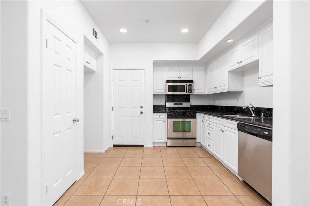 63 Nightshade Irvine, CA 92603 - Photo 5 of 15 a kitchen with stainless steel appliances granite countertop a refrigerator and a sink