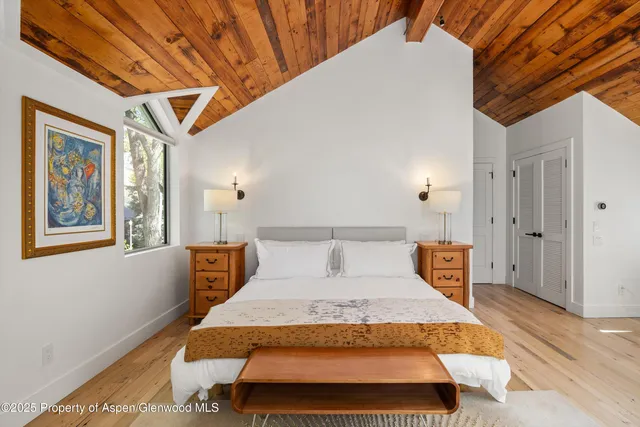 a large white kitchen with a large window