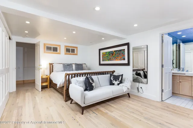 a workspace with wooden floor and furniture