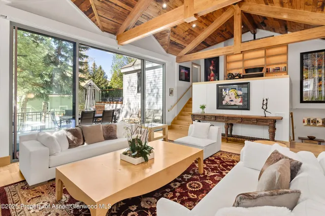 a living room with furniture and a floor to ceiling window