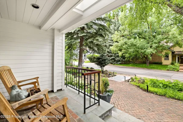 a view of yard from deck with patio