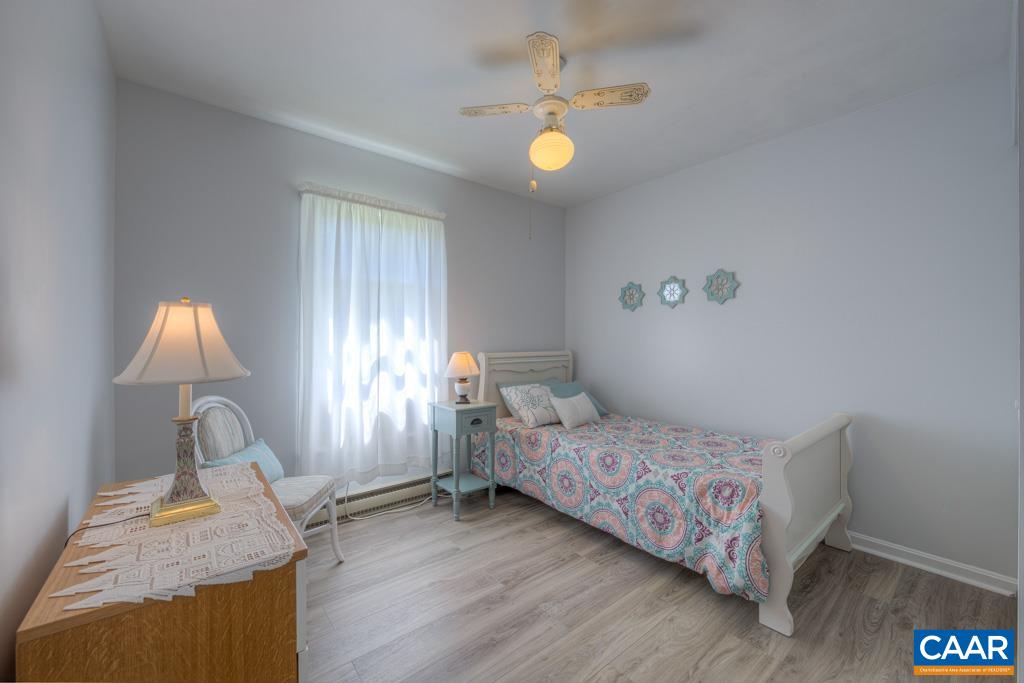 2475 Ridge Road Palmyra, VA 22963 - Photo 17 of 25 a bedroom with a bed and a chandelier