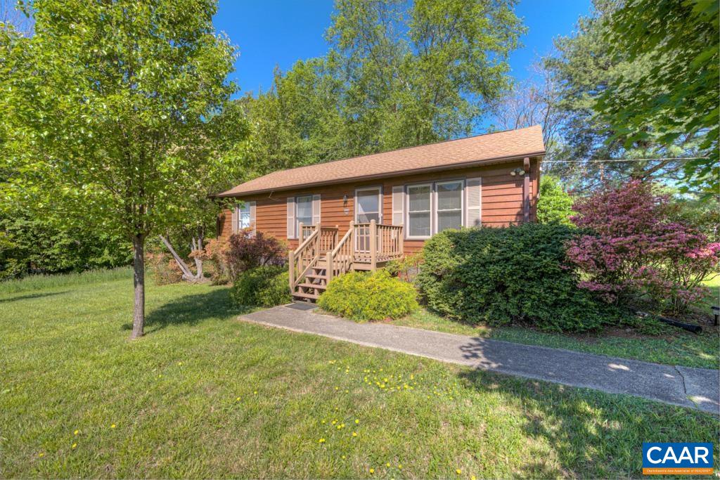 2475 Ridge Road Palmyra, VA 22963 - Photo 2 of 25 a view of a yard in front of a house with plants and large tree