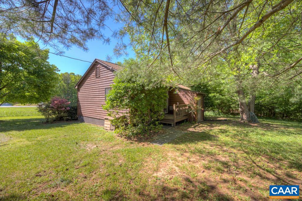 2475 Ridge Road Palmyra, VA 22963 - Photo 23 of 25 a view of a backyard with fountain plants and large tree