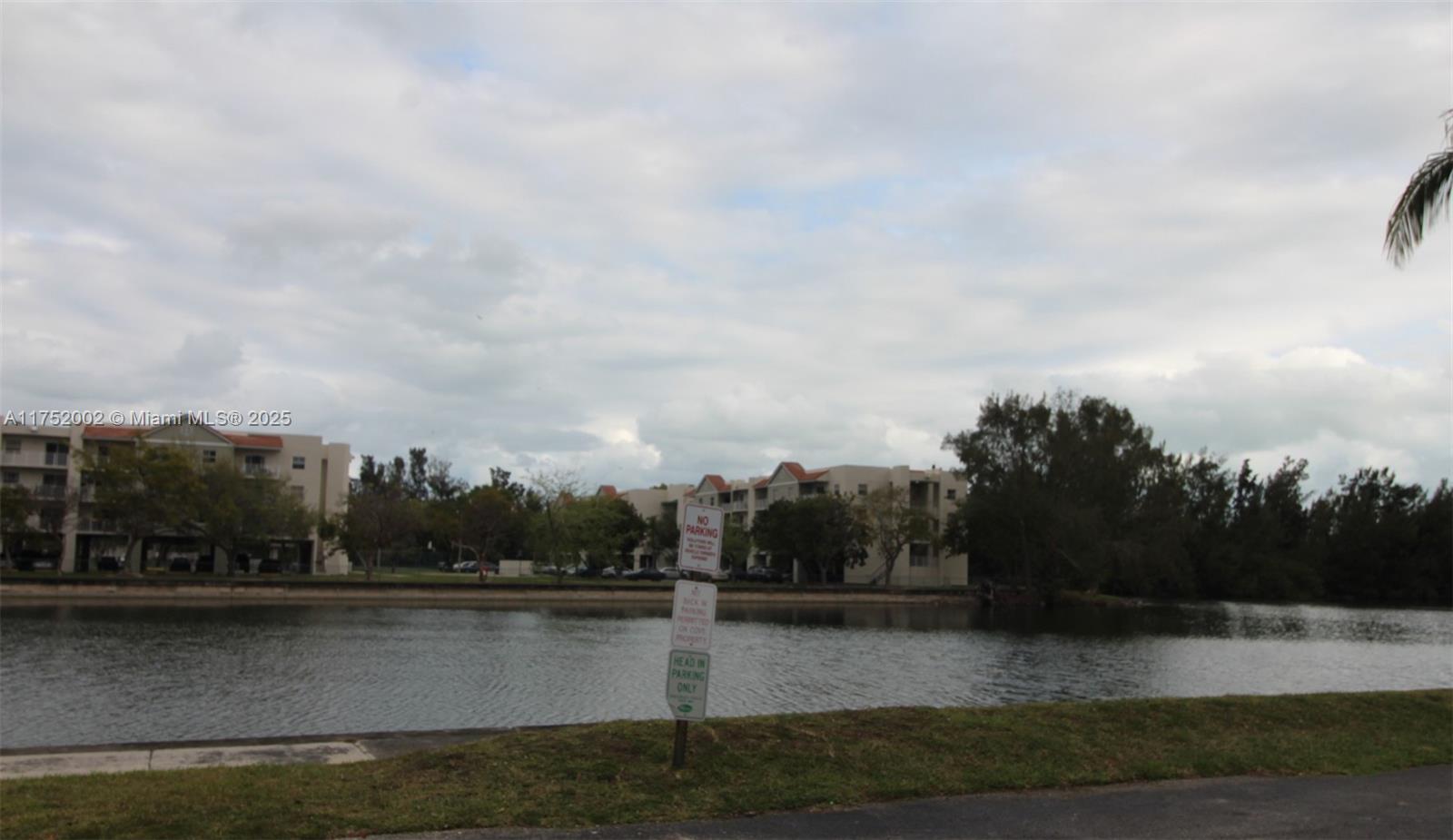 21133 Southwest 85th Avenue, Unit 112 Cutler Bay, FL 33189 - Photo 2 of 18 a view of a lake with houses in back