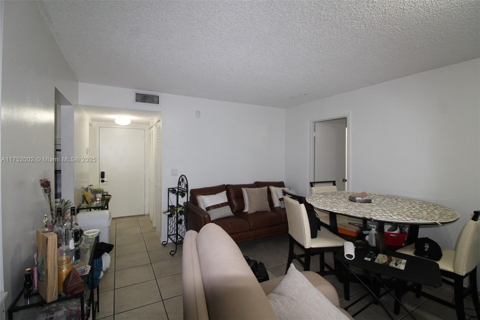 21133 Southwest 85th Avenue, Unit 112 Cutler Bay, FL 33189 - Photo 5 of 18 a view of a dining room with furniture and wooden floor