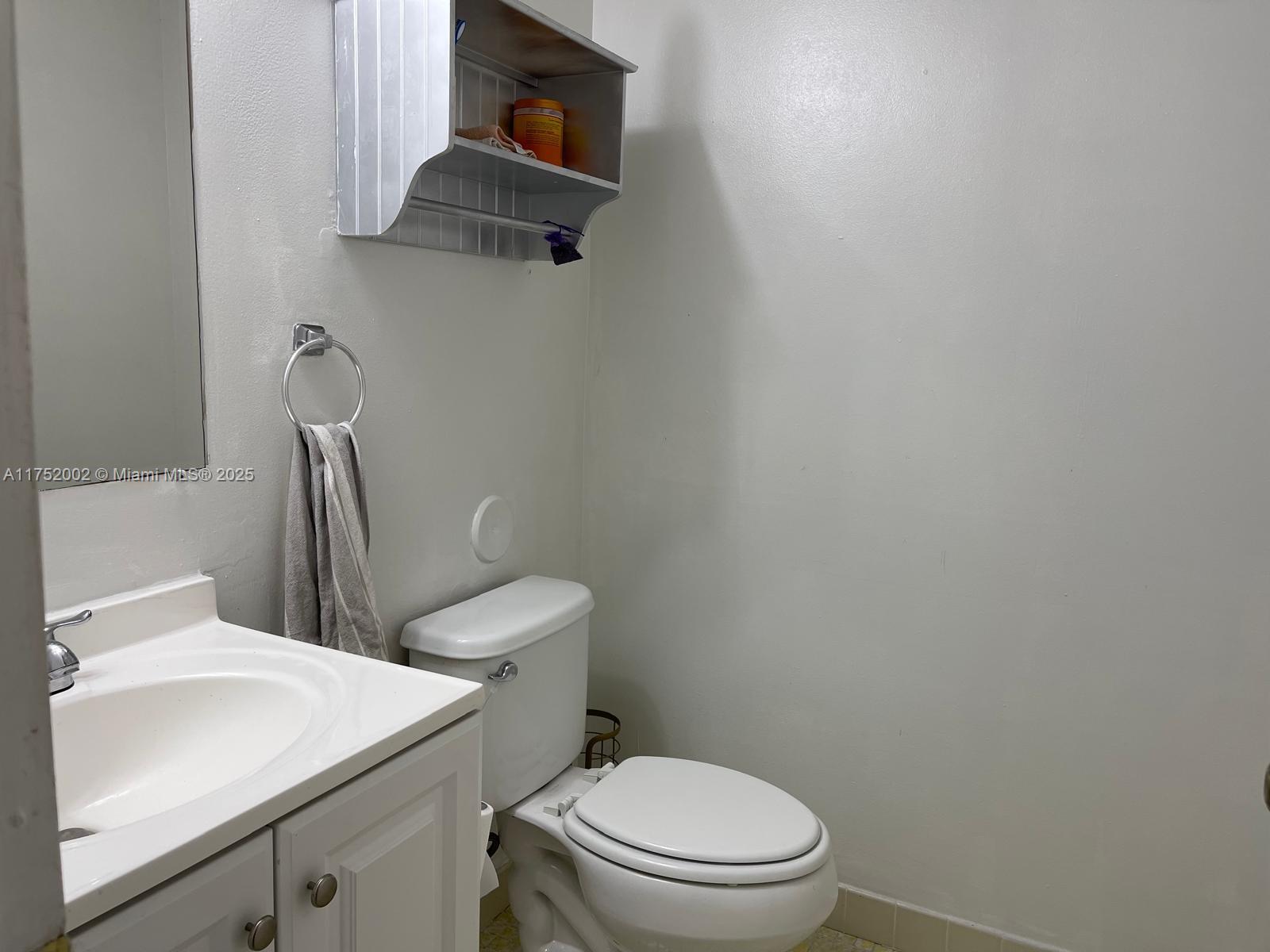 21133 Southwest 85th Avenue, Unit 112 Cutler Bay, FL 33189 - Photo 7 of 18 a white toilet sitting next to a bathroom sink