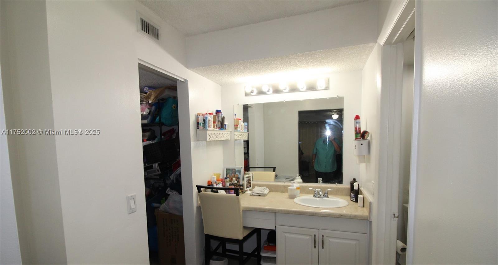 21133 Southwest 85th Avenue, Unit 112 Cutler Bay, FL 33189 - Photo 10 of 18 a bathroom with a sink vanity and mirror