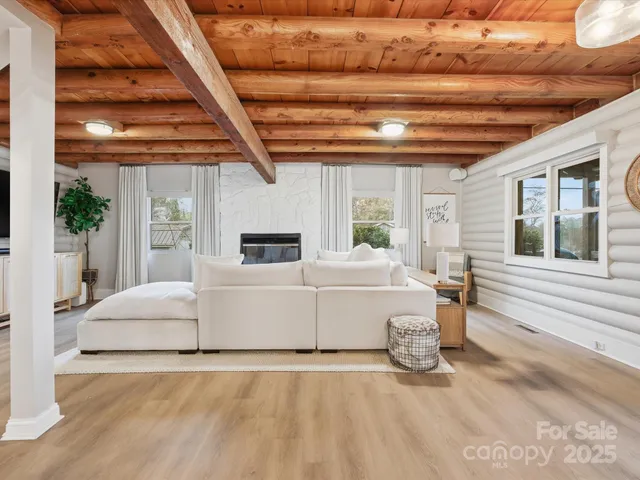 a white bed sitting in a room next to a window