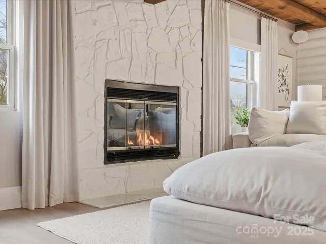 a bedroom with a bed and a fireplace