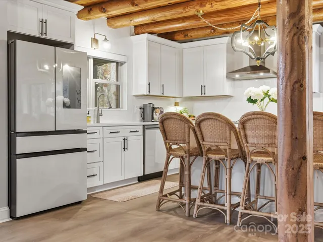 a kitchen with cabinets and chairs