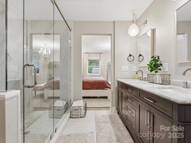 a spacious bathroom with a double vanity sink mirror and shower